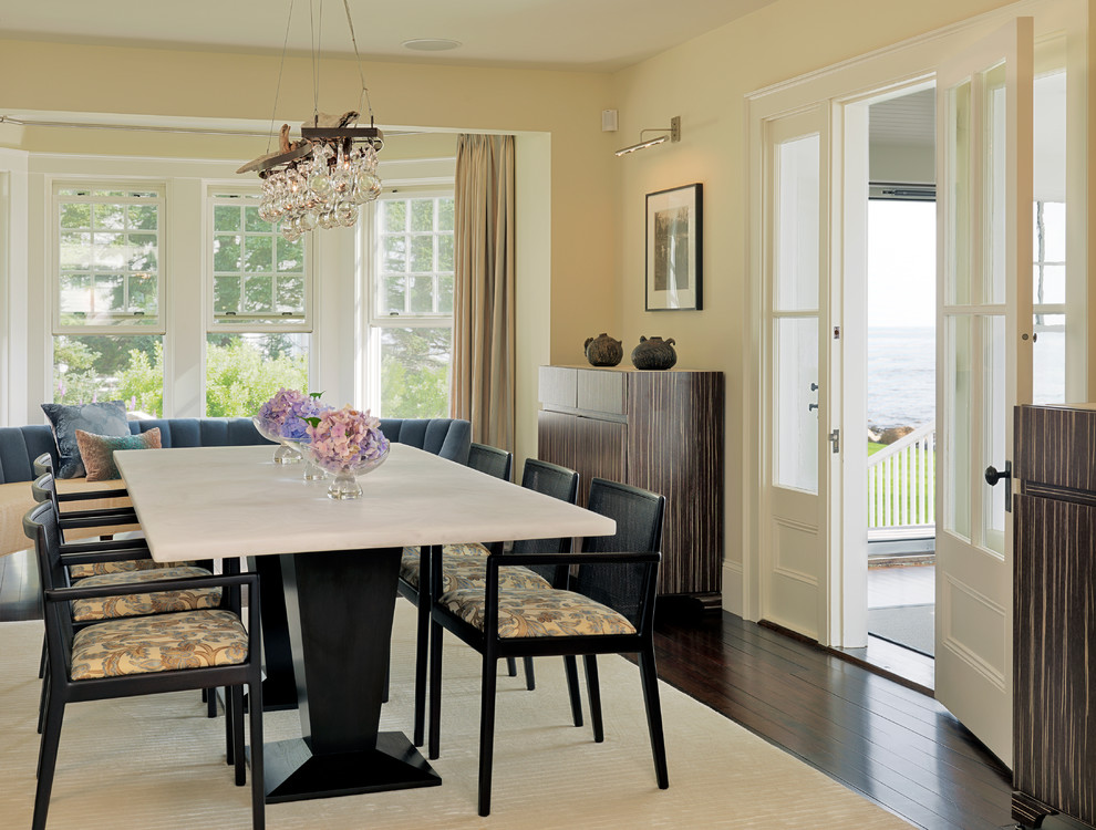 Contemporary dining room in Boston with beige walls and dark hardwood floors.