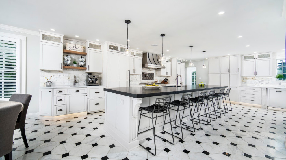 Inspiration for a huge l-shaped porcelain tile and white floor eat-in kitchen remodel with an undermount sink, shaker cabinets, white cabinets, granite countertops, white backsplash, ceramic backsplash, stainless steel appliances, two islands and black countertops