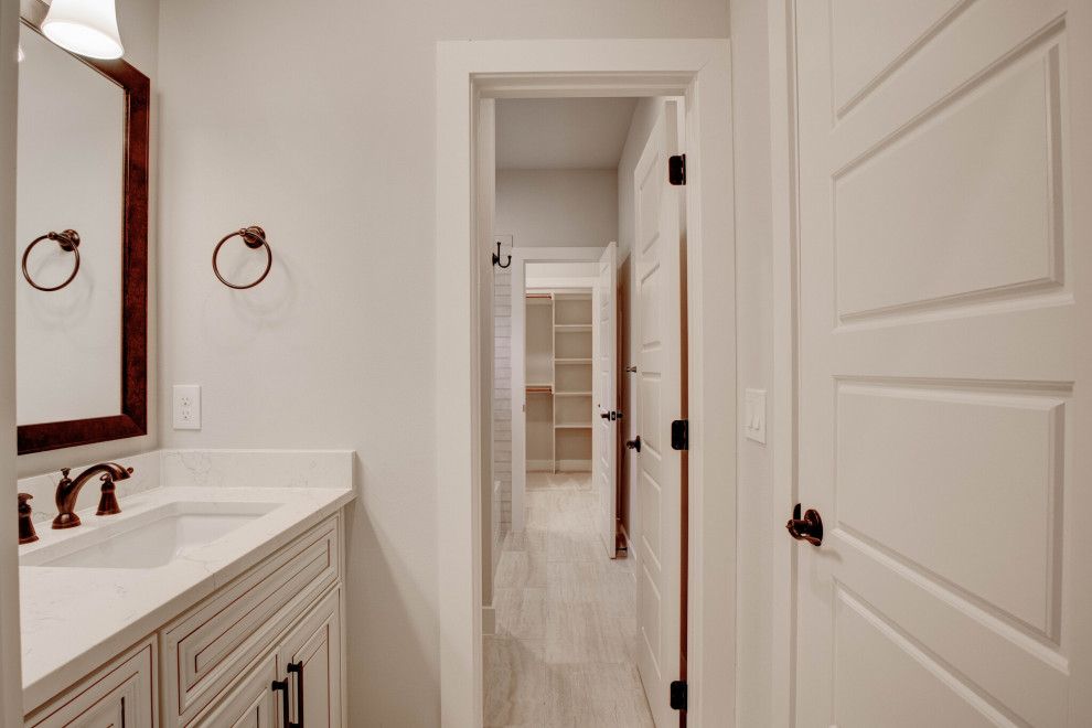 Design ideas for a mid-sized transitional kids bathroom in Dallas with raised-panel cabinets, beige cabinets, a drop-in tub, an alcove shower, wood-look tile, an undermount sink, beige floor, an open shower, white benchtops, a double vanity and a built-in vanity.