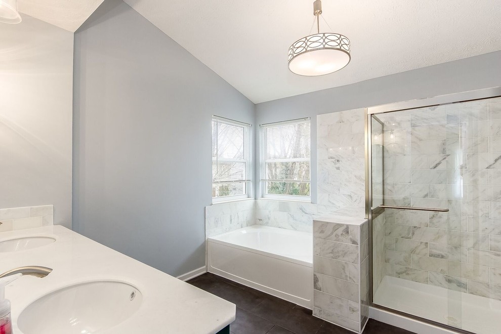 Inspiration for a mid-sized transitional master bathroom in Columbus with furniture-like cabinets, turquoise cabinets, a drop-in tub, an alcove shower, white tile, marble, grey walls, porcelain floors, an undermount sink, marble benchtops, brown floor and a sliding shower screen.
