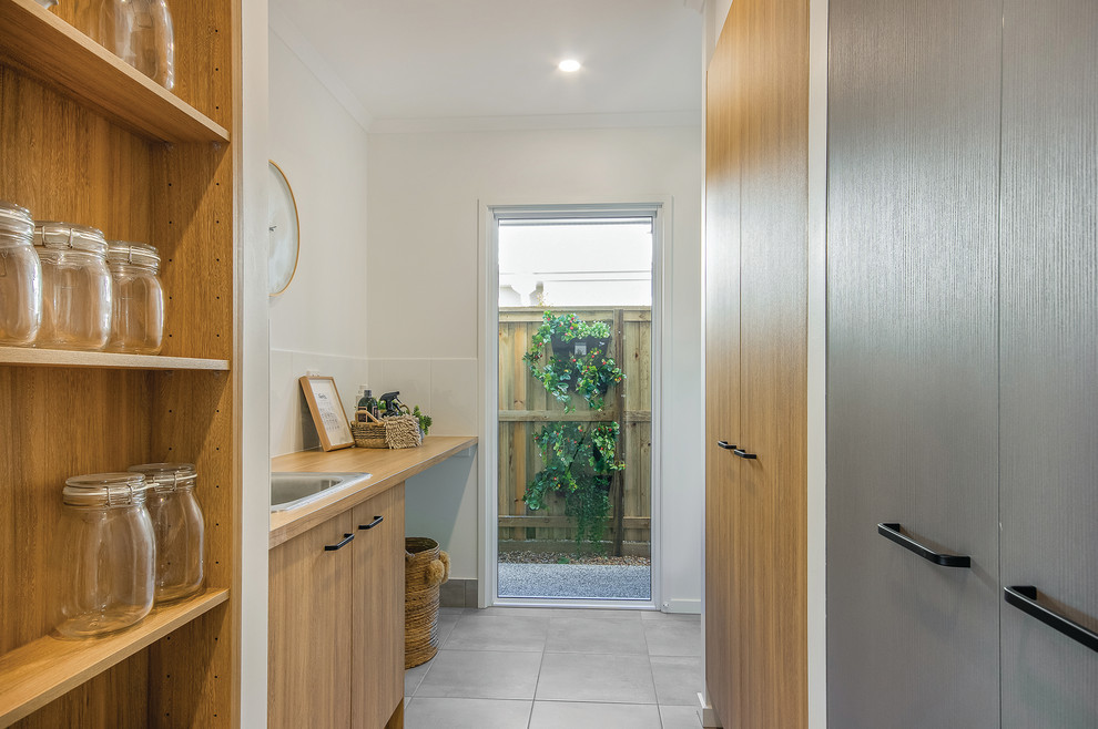 This is an example of a beach style laundry room in Sunshine Coast.