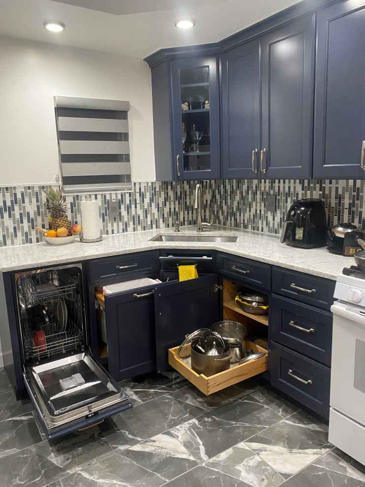 Inspiration for a transitional l-shaped kitchen in New York with an undermount sink, recessed-panel cabinets, blue cabinets, quartz benchtops, multi-coloured splashback, glass sheet splashback, white appliances, porcelain floors, no island, multi-coloured floor, multi-coloured benchtop and recessed.