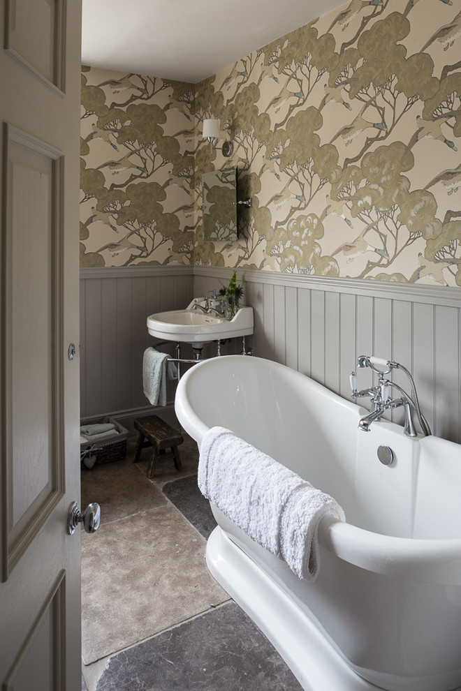 Photo of a traditional 3/4 bathroom in Other with a freestanding tub, beige walls, a console sink and grey floor.