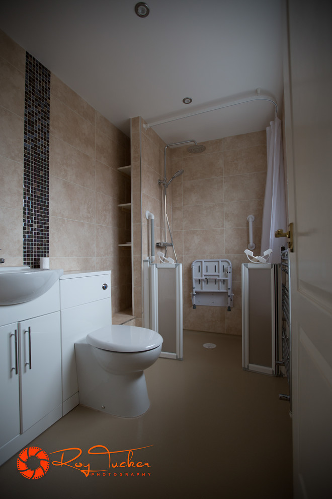 This is an example of a small contemporary master wet room bathroom in Other with flat-panel cabinets, white cabinets, a one-piece toilet, beige tile, ceramic tile, vinyl floors and a drop-in sink.