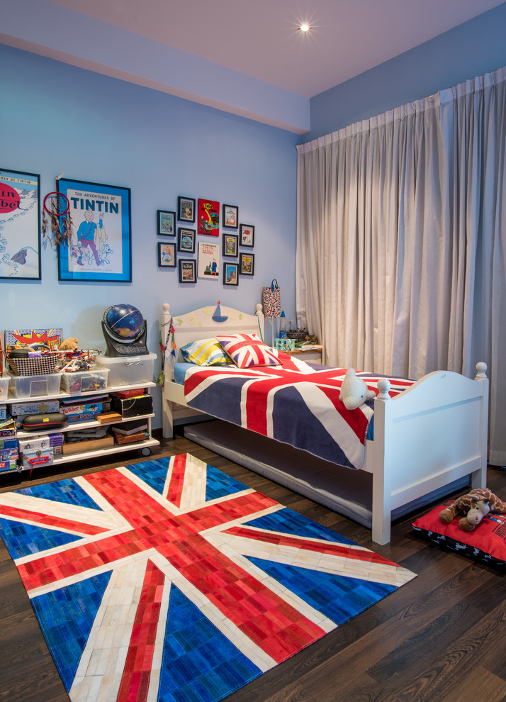 Photo of a transitional kids' bedroom for kids 4-10 years old and boys in Singapore with blue walls, dark hardwood floors and brown floor.