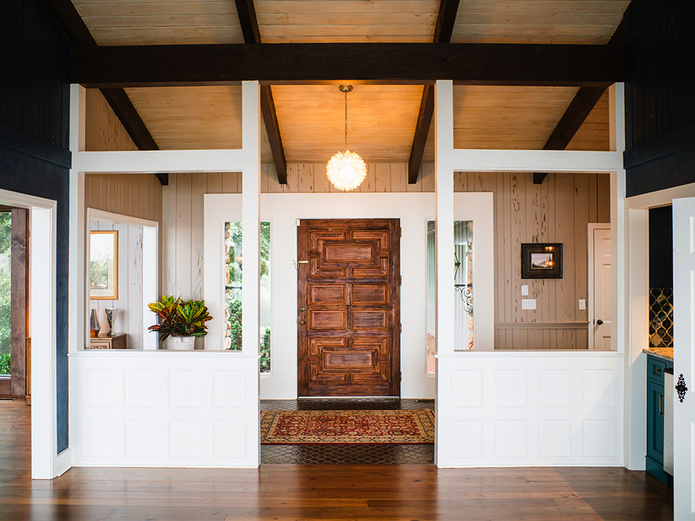 Mid-sized transitional ceramic tile front door photo with multicolored walls and a dark wood front door