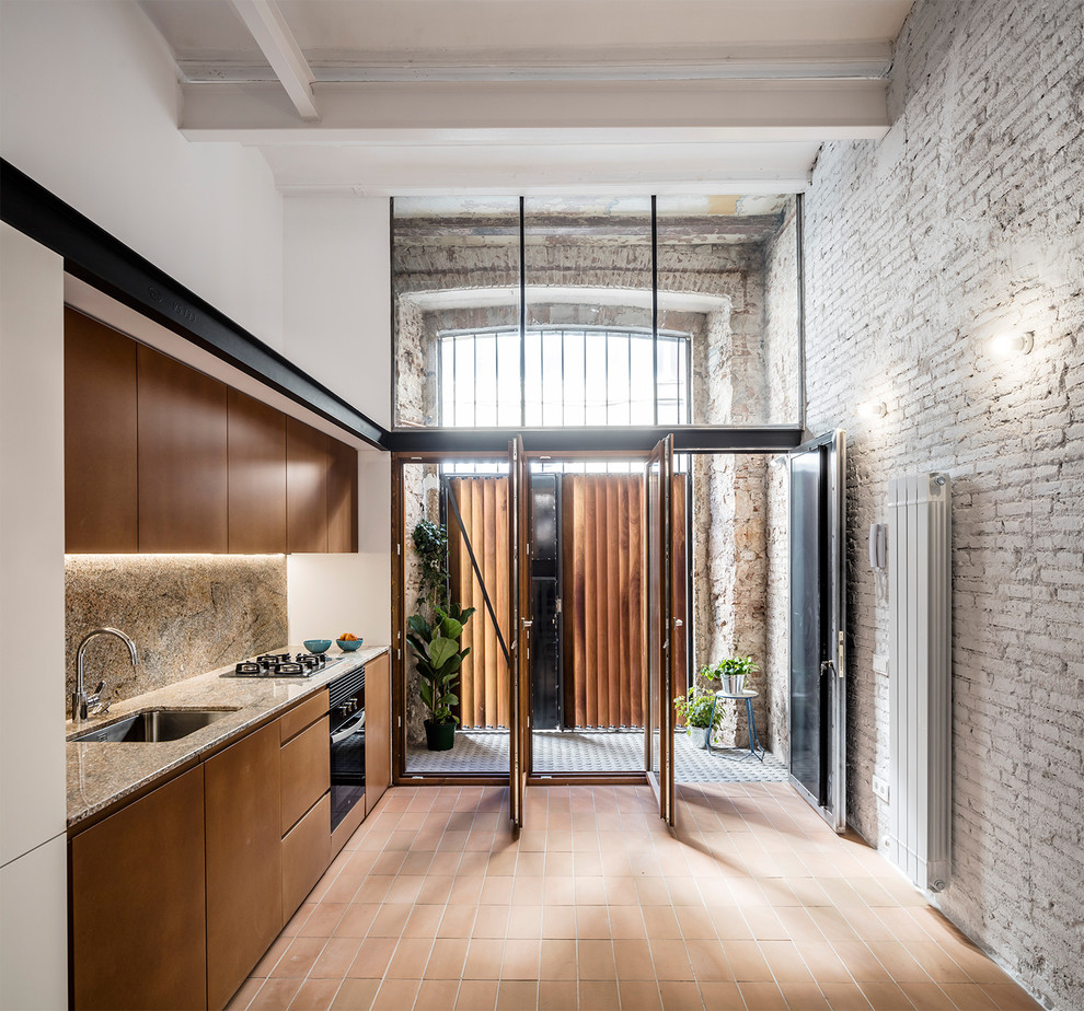 Inspiration for a mid-sized contemporary single-wall kitchen in Barcelona with flat-panel cabinets, brown cabinets, terra-cotta floors, no island, red floor, a single-bowl sink, brown splashback and black appliances.