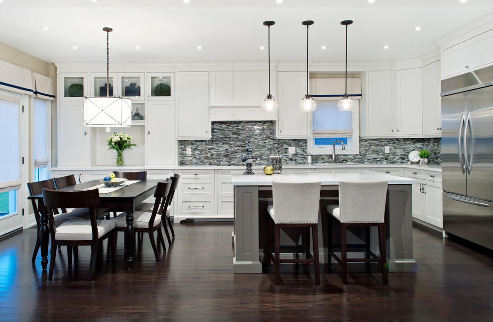 Photo of a large transitional l-shaped eat-in kitchen in Toronto with an undermount sink, beaded inset cabinets, white cabinets, multi-coloured splashback, matchstick tile splashback, stainless steel appliances, quartz benchtops and dark hardwood floors.
