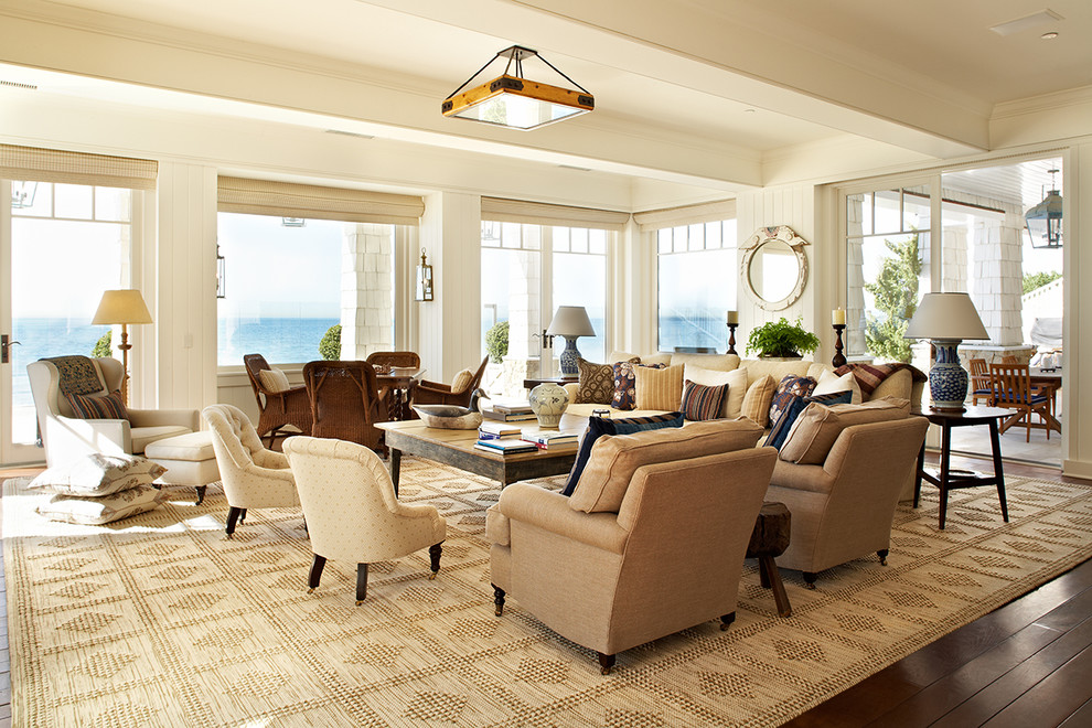 This is an example of a beach style living room in Los Angeles with beige walls, dark hardwood floors, no fireplace and no tv.