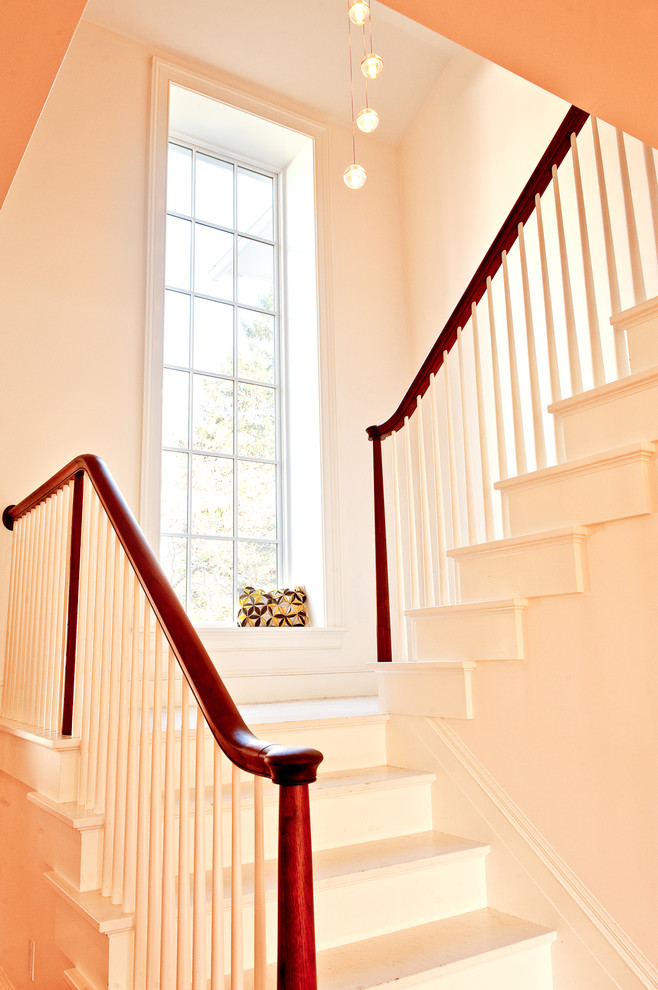 This is an example of a country u-shaped staircase in Boston with painted wood risers.