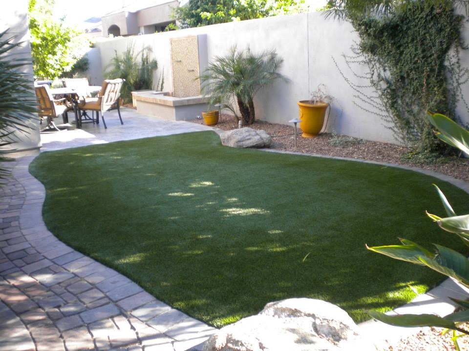 Photo of a mid-sized tropical backyard full sun outdoor sport court for fall in Phoenix with decking.