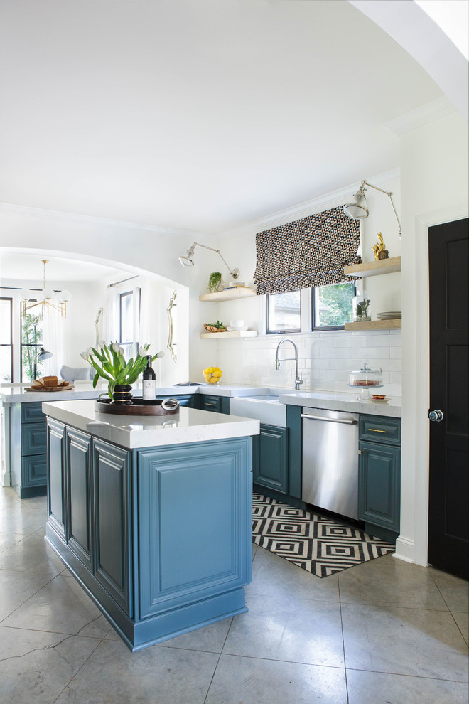Kitchen - mid-sized transitional concrete floor and beige floor kitchen idea with a farmhouse sink, white backsplash, subway tile backsplash, stainless steel appliances, an island and white countertops