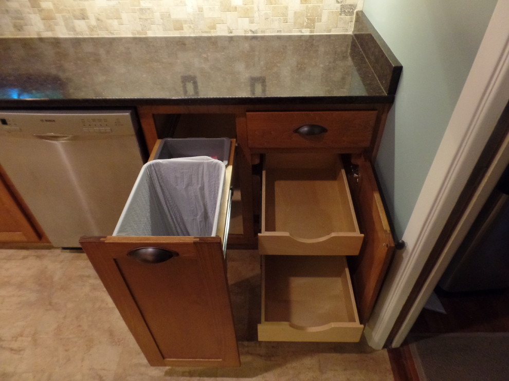 Example of a mid-sized transitional galley home design design with an undermount sink, shaker cabinets, medium tone wood cabinets, quartz countertops, multicolored backsplash, travertine backsplash, colored appliances and no island