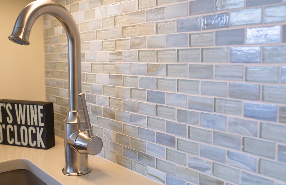 Example of a large transitional u-shaped porcelain tile and beige floor enclosed kitchen design in Miami with an undermount sink, beaded inset cabinets, white cabinets, quartzite countertops, blue backsplash, subway tile backsplash, stainless steel appliances and an island