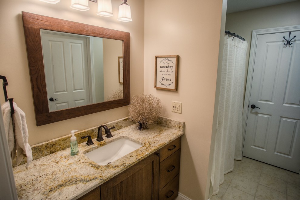 Photo of a transitional kids bathroom in Other with an alcove tub, a shower/bathtub combo, beige tile, beige walls, ceramic floors, an undermount sink and granite benchtops.