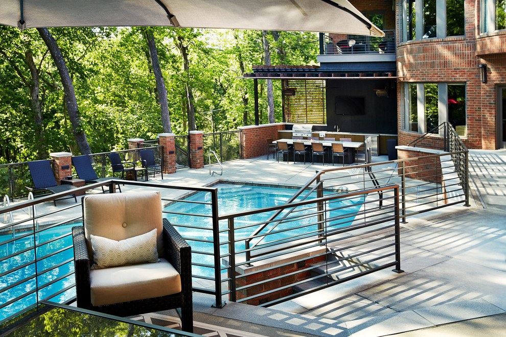 Example of a huge trendy backyard concrete and custom-shaped pool design