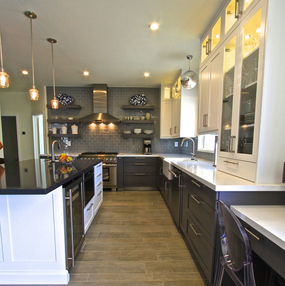 Transitional porcelain tile kitchen photo in Orange County with glass tile backsplash and an island