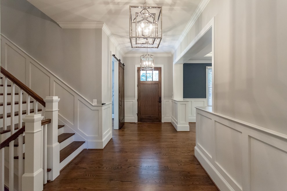 Home design - transitional medium tone wood floor and brown floor home design idea in DC Metro with gray walls and a medium wood front door