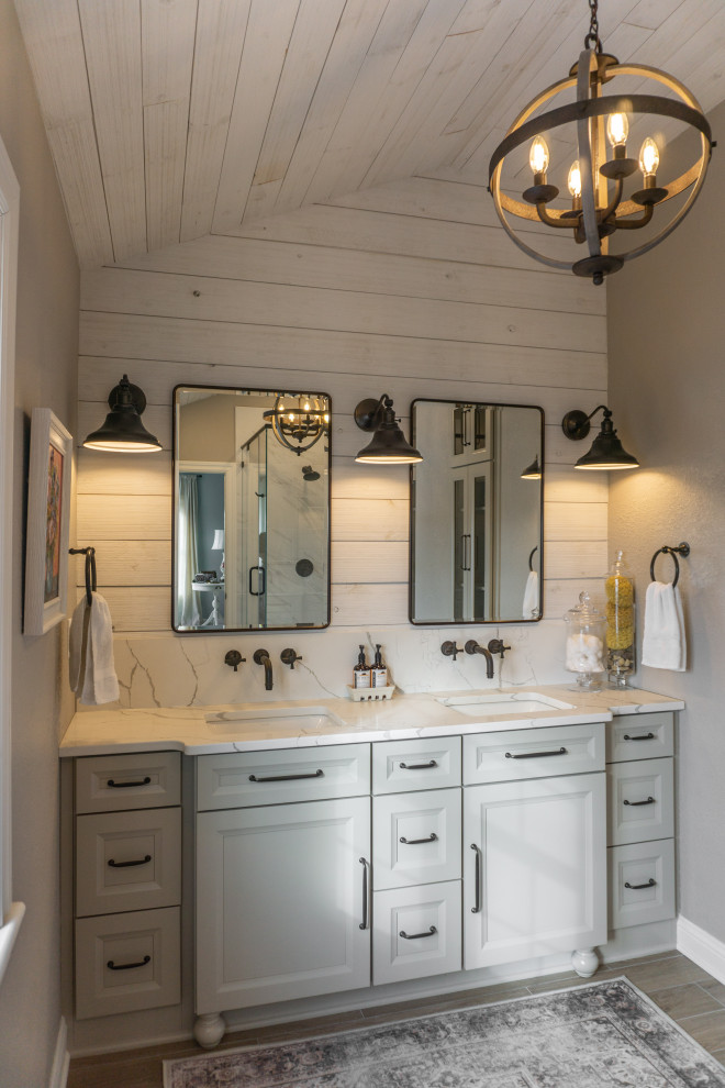 Photo of a large country master bathroom in Milwaukee with flat-panel cabinets, grey cabinets, a corner shower, a one-piece toilet, black and white tile, wood-look tile, grey walls, an undermount sink, quartzite benchtops, beige floor, a hinged shower door, beige benchtops, a niche, a double vanity, a built-in vanity, vaulted and planked wall panelling.