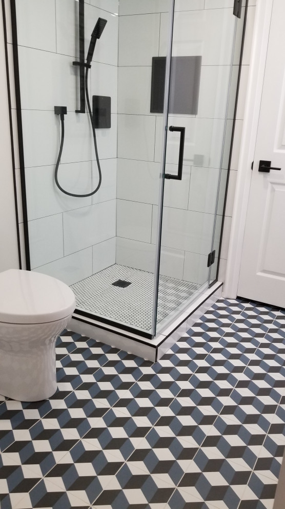 Inspiration for a small 1960s white tile and porcelain tile ceramic tile and single-sink bathroom remodel in Toronto with flat-panel cabinets, medium tone wood cabinets, a one-piece toilet, white walls, an integrated sink, solid surface countertops, a hinged shower door, a niche and a built-in vanity