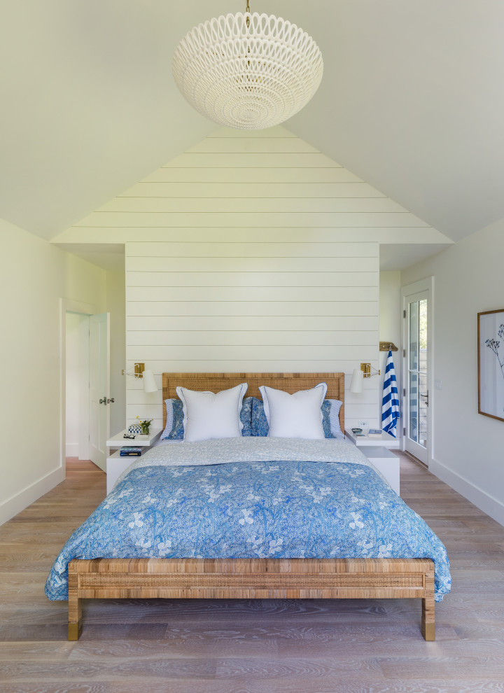 Design ideas for a beach style bedroom in Boston with white walls, medium hardwood floors, brown floor, vaulted and planked wall panelling.