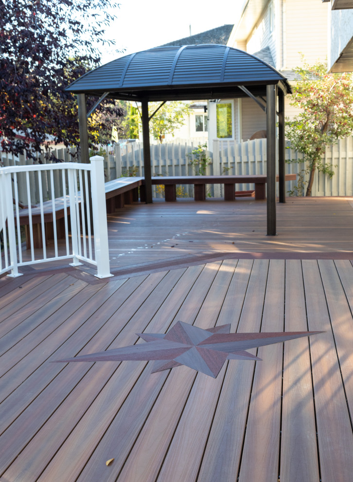 Expansive modern backyard and ground level deck in Edmonton with no cover and metal railing.