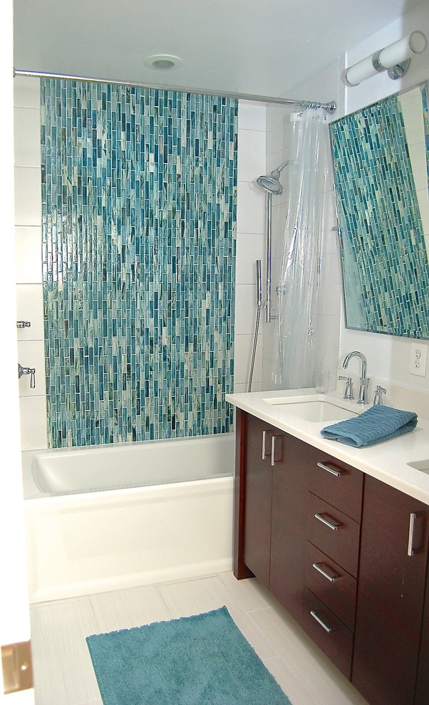 Small contemporary 3/4 bathroom in Baltimore with dark wood cabinets, engineered quartz benchtops, blue tile, glass tile, white walls, ceramic floors, an alcove tub, a shower/bathtub combo and an undermount sink.
