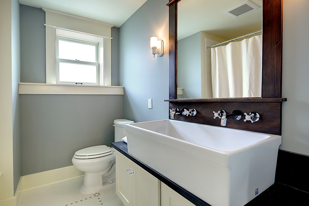 Photo of a traditional bathroom in Seattle with a trough sink and white cabinets.