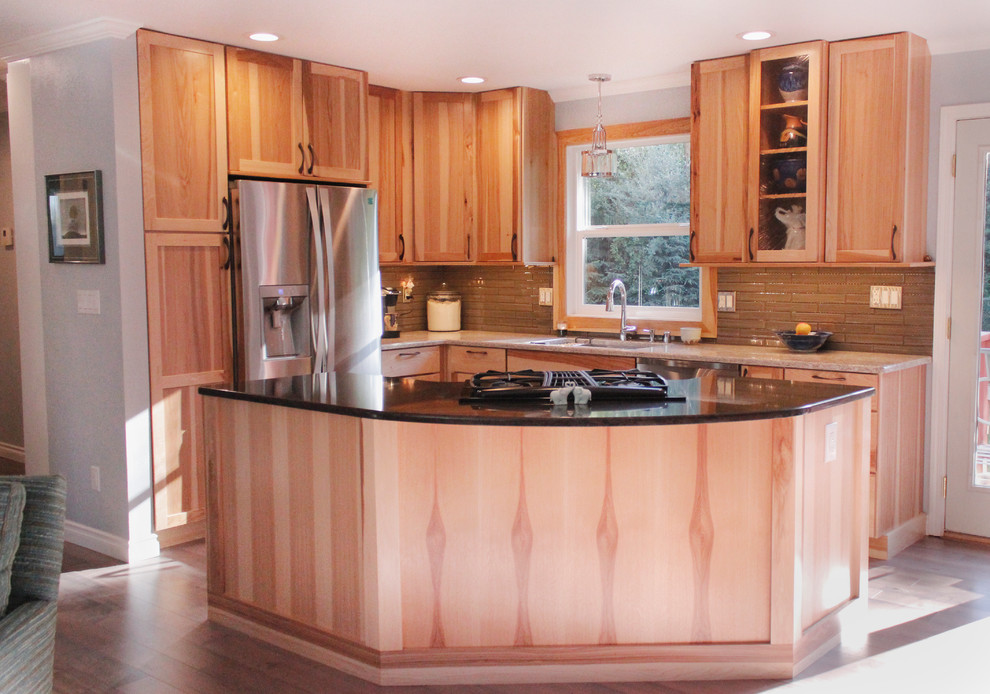 Inspiration for a small transitional l-shaped medium tone wood floor open concept kitchen remodel with an undermount sink, shaker cabinets, light wood cabinets, granite countertops, beige backsplash, stainless steel appliances and an island