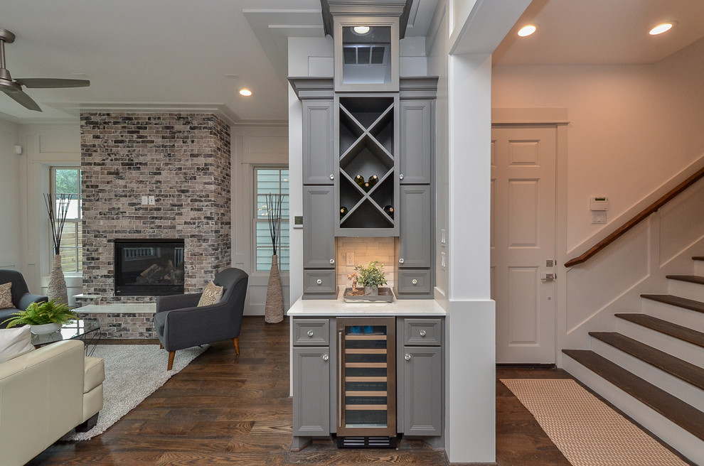 Small traditional single-wall home bar in Houston with no sink, recessed-panel cabinets, grey cabinets, white splashback, dark hardwood floors, brown floor and white benchtop.