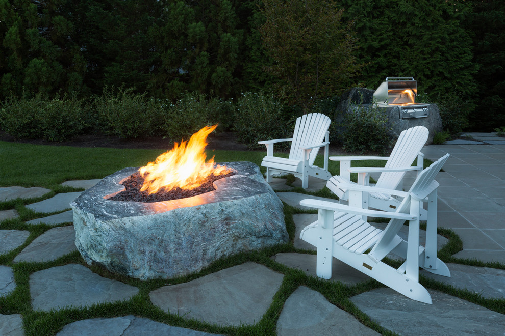 Photo of a large traditional backyard patio in Boston with a fire feature, natural stone pavers and no cover.