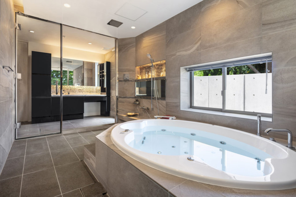 Drop-in bathtub - modern gray tile gray floor and tray ceiling drop-in bathtub idea with gray walls