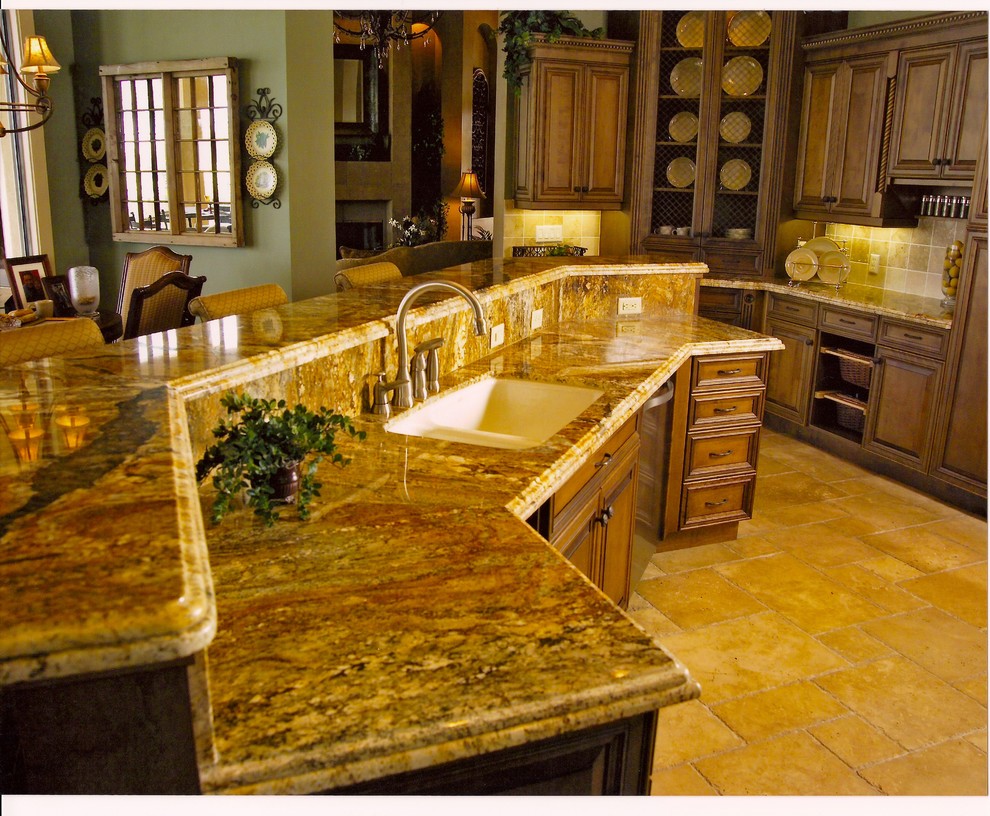 Inspiration for a mid-sized transitional galley open plan kitchen in Miami with a double-bowl sink, raised-panel cabinets, medium wood cabinets, limestone benchtops, brown splashback, stone tile splashback, stainless steel appliances, marble floors and with island.