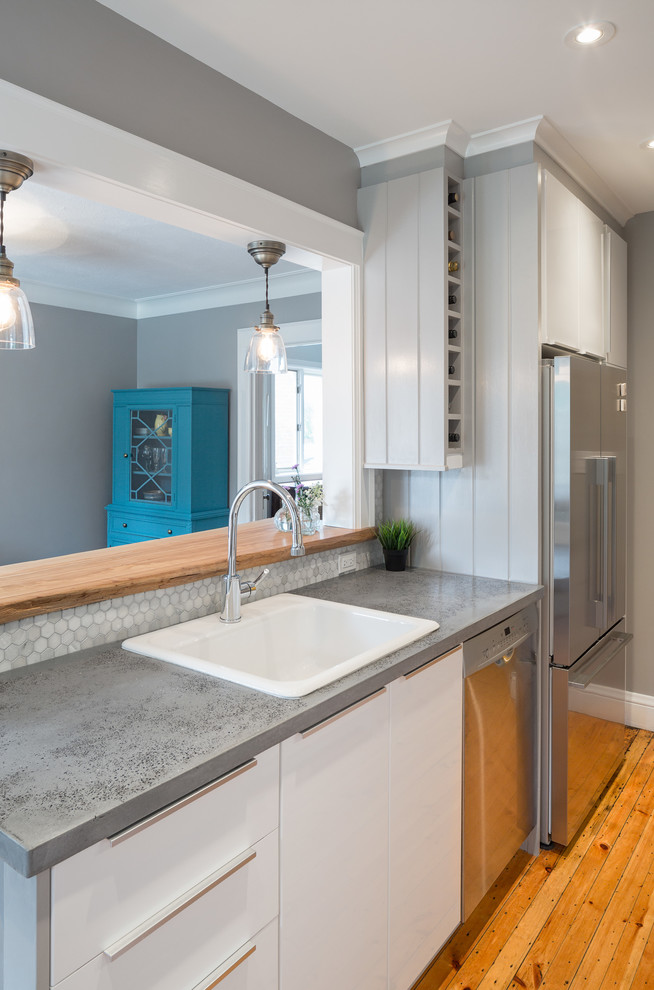 Photo of a small transitional galley eat-in kitchen in Ottawa with a single-bowl sink, flat-panel cabinets, white cabinets, wood benchtops, beige splashback, mosaic tile splashback, stainless steel appliances and light hardwood floors.