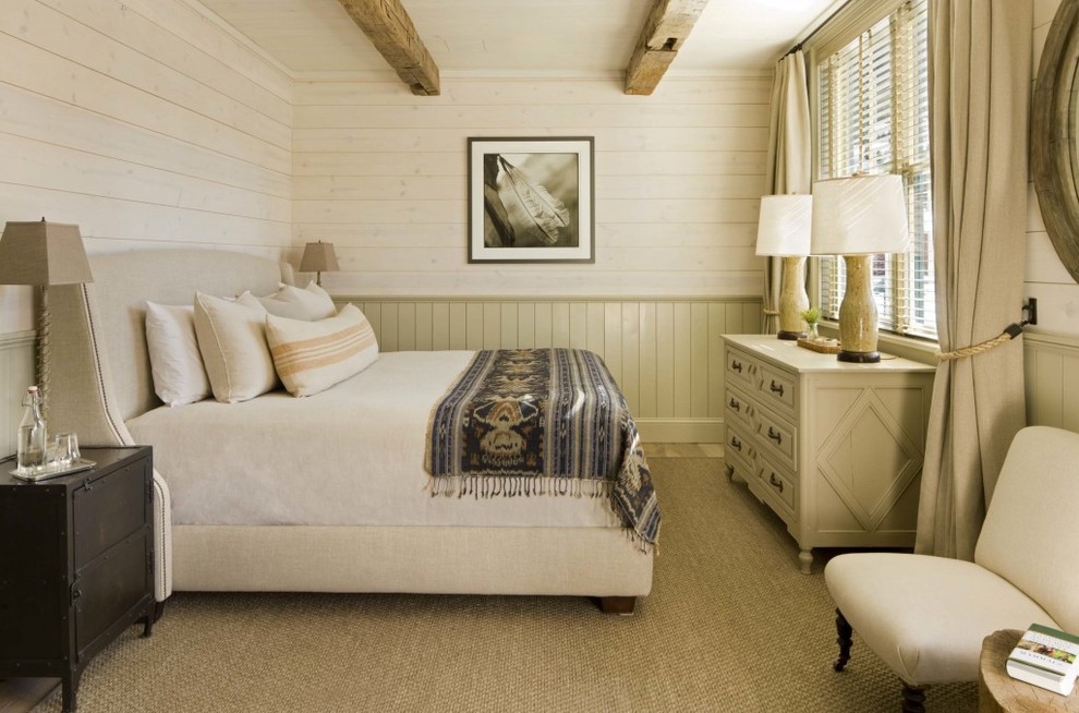 This is an example of a country bedroom in Denver with beige walls.