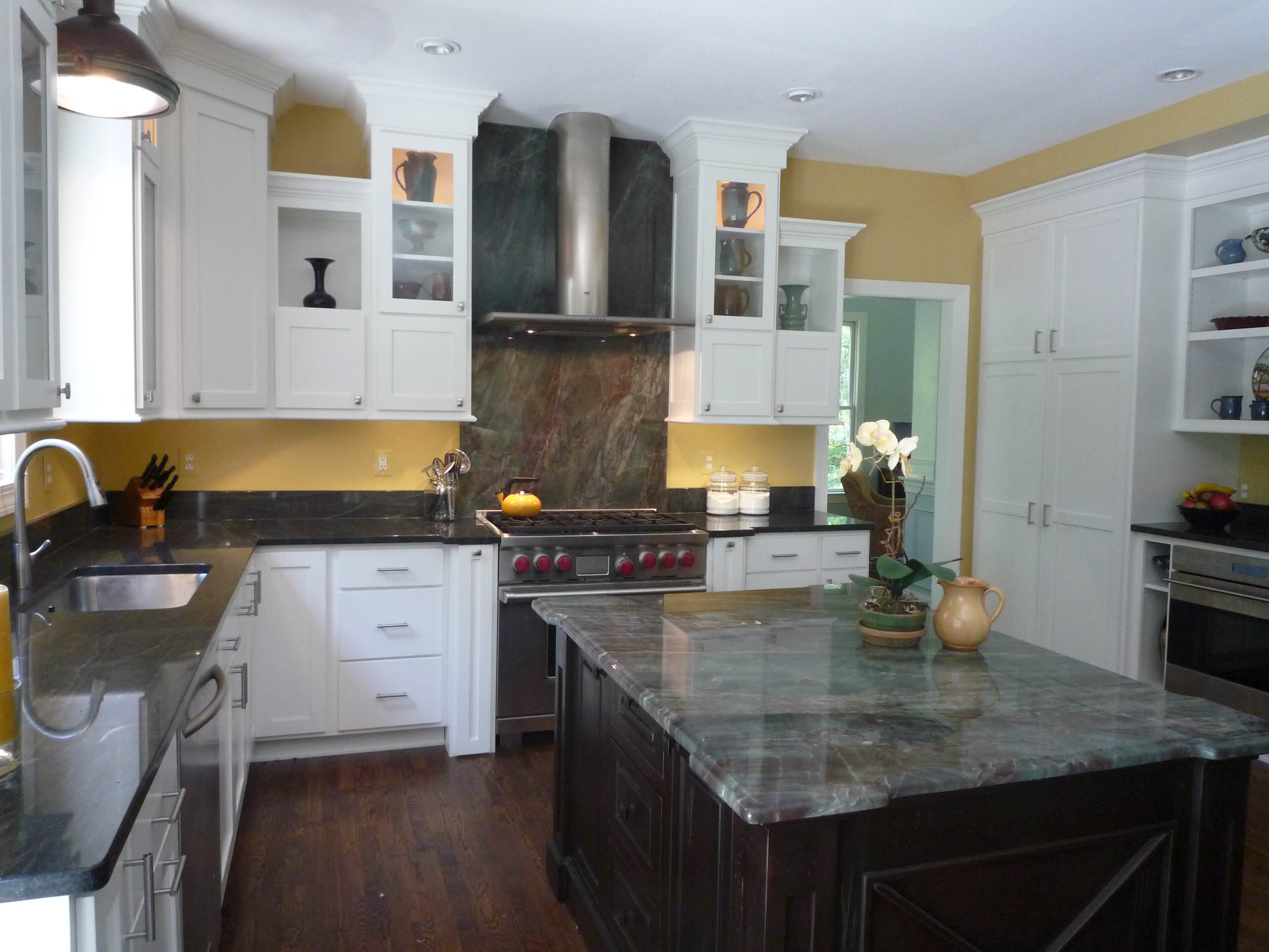 yellow kitchen with Green Fire granite and white cabinets