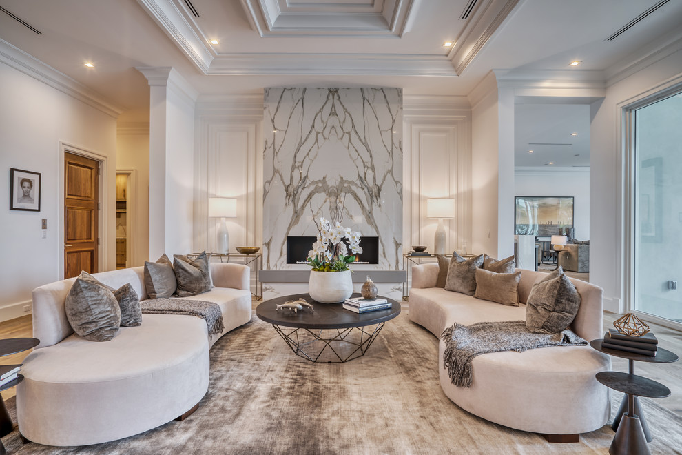 This is an example of a transitional living room in Miami with white walls, medium hardwood floors, a ribbon fireplace and brown floor.