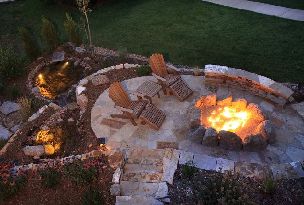 Design ideas for a mid-sized traditional backyard full sun garden for summer in Denver with a fire feature and natural stone pavers.