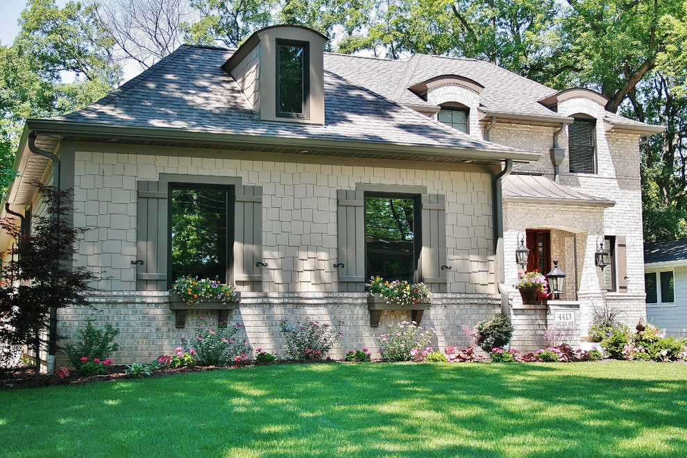 Large transitional two-storey beige exterior in Chicago with mixed siding and a hip roof.
