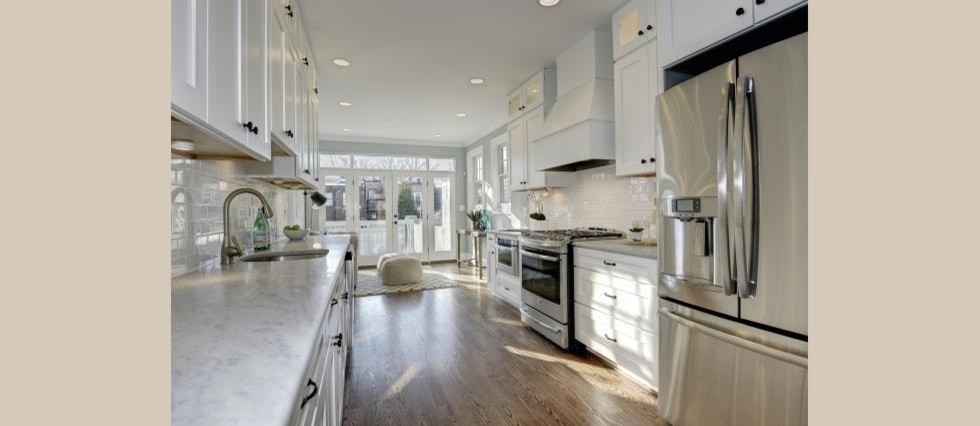 Mid-sized transitional galley medium tone wood floor eat-in kitchen photo in DC Metro with an undermount sink, shaker cabinets, white cabinets, marble countertops, white backsplash, subway tile backsplash and stainless steel appliances
