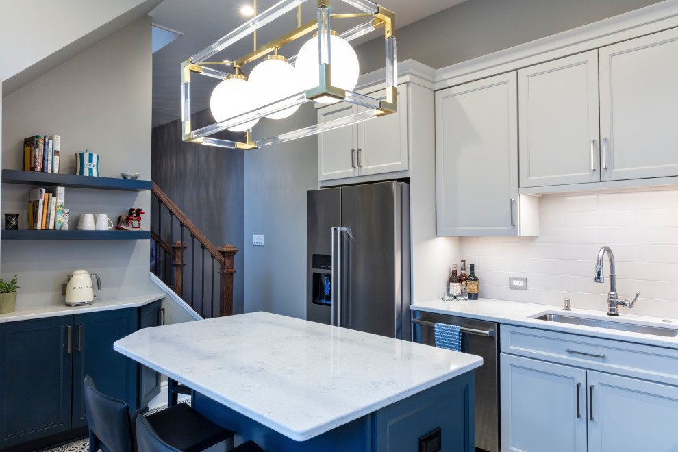 Inspiration for a transitional porcelain tile kitchen remodel with white backsplash, ceramic backsplash, stainless steel appliances, an island and white countertops
