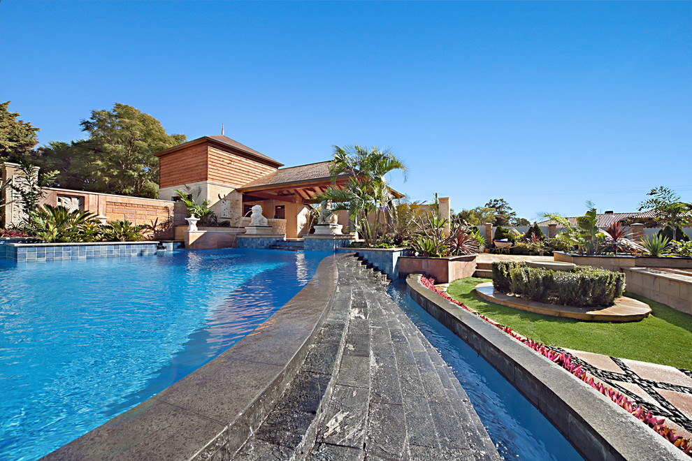 Photo of an expansive mediterranean backyard custom-shaped infinity pool in Perth with a water feature and decking.