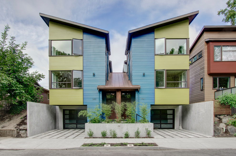 Design ideas for a modern three-storey blue exterior in Portland with concrete fiberboard siding.