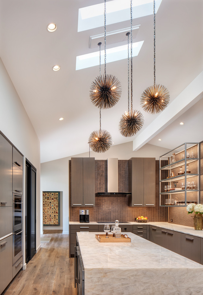 Inspiration for a contemporary u-shaped kitchen in Chicago with flat-panel cabinets, grey cabinets, brown splashback, mosaic tile splashback, stainless steel appliances, medium hardwood floors, with island, brown floor, white benchtop and vaulted.