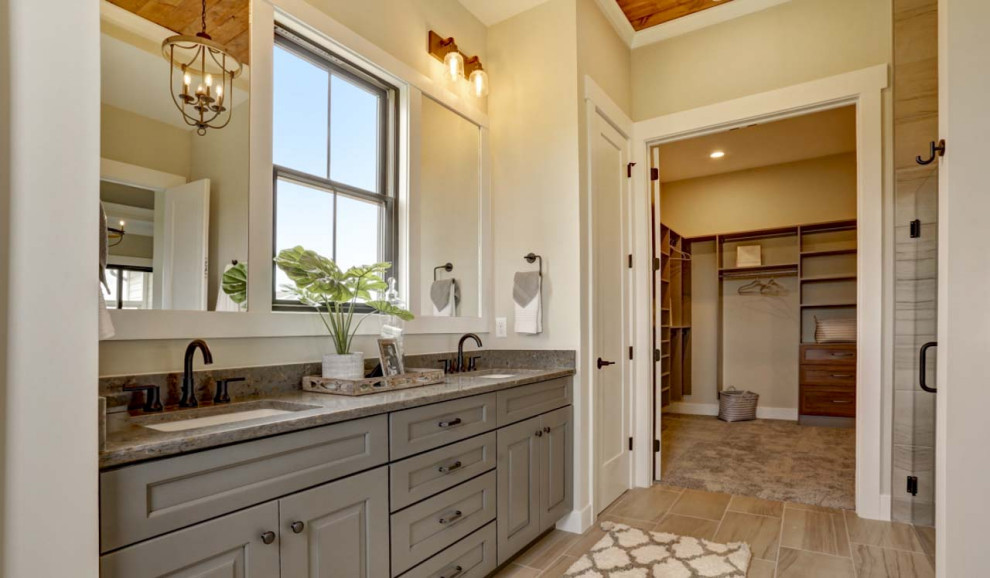 This is an example of a large arts and crafts master bathroom in Other with grey cabinets, an alcove shower, beige walls, ceramic floors, an integrated sink, marble benchtops, beige floor, a hinged shower door, brown benchtops, a double vanity, a built-in vanity and wood.
