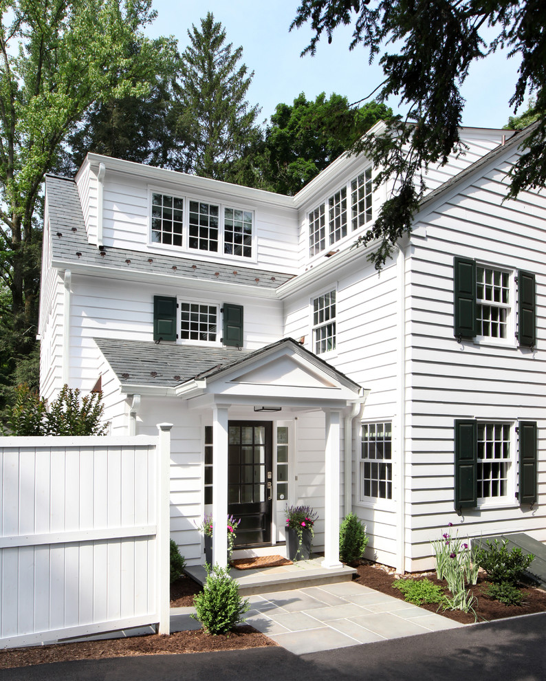 Large traditional three-storey white house exterior in Other with wood siding, a gable roof and a tile roof.