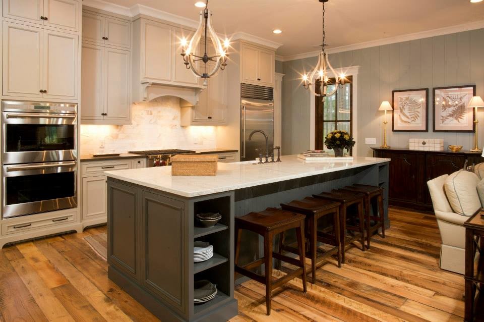 This is an example of an expansive traditional open plan kitchen in Charleston with recessed-panel cabinets, beige cabinets, granite benchtops, stainless steel appliances, medium hardwood floors and with island.