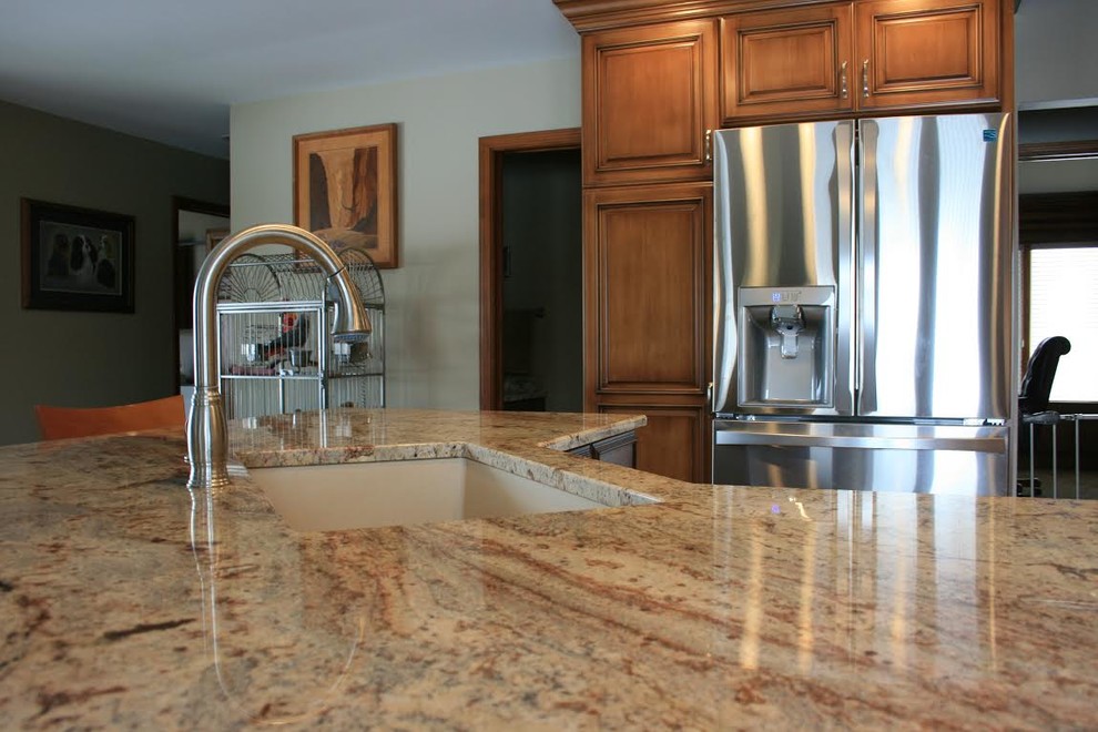 Mid-sized transitional kitchen photo with an undermount sink, raised-panel cabinets, medium tone wood cabinets, granite countertops, stainless steel appliances and an island