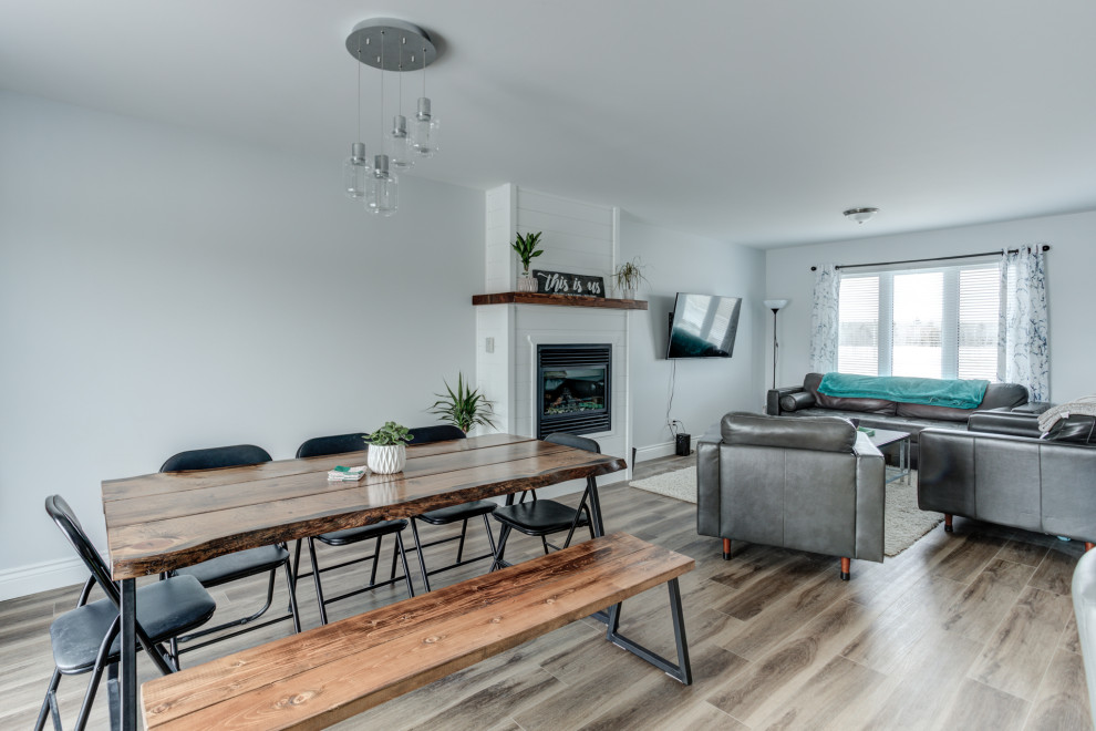 Minimalist vinyl floor and brown floor dining room photo with blue walls, a standard fireplace and a shiplap fireplace