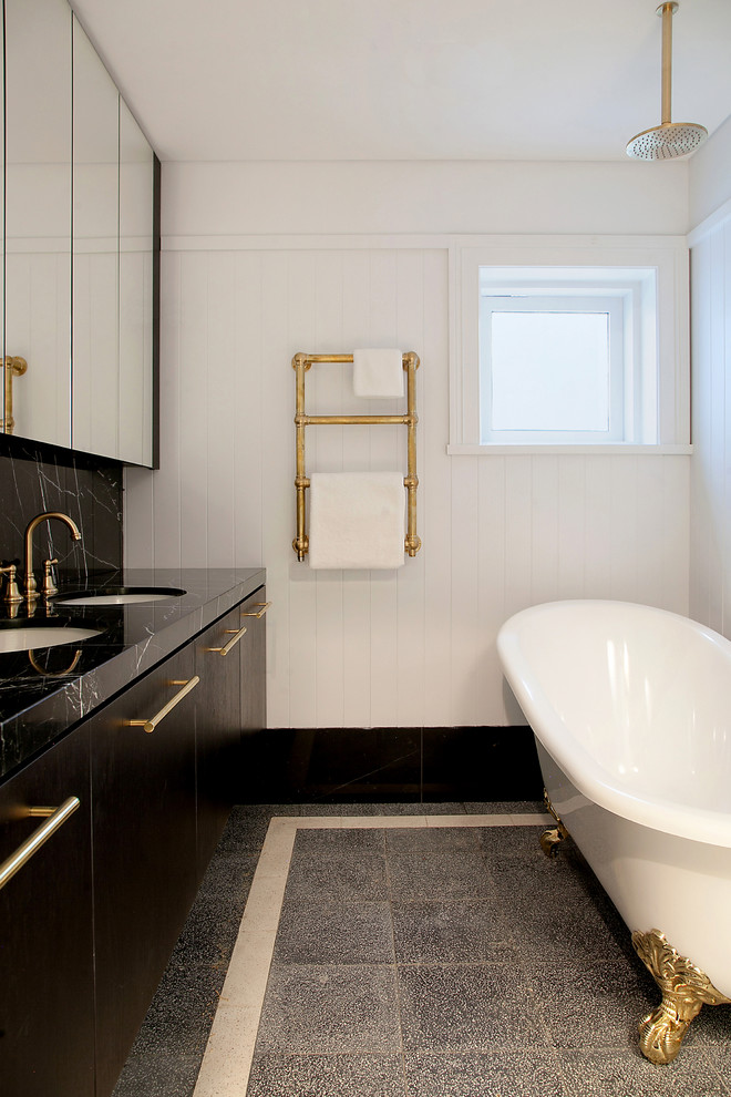 This is an example of a small contemporary master bathroom in Sydney with black cabinets, a claw-foot tub, a shower/bathtub combo, white tile, porcelain tile, white walls, marble floors, an integrated sink, marble benchtops, black floor, an open shower and black benchtops.